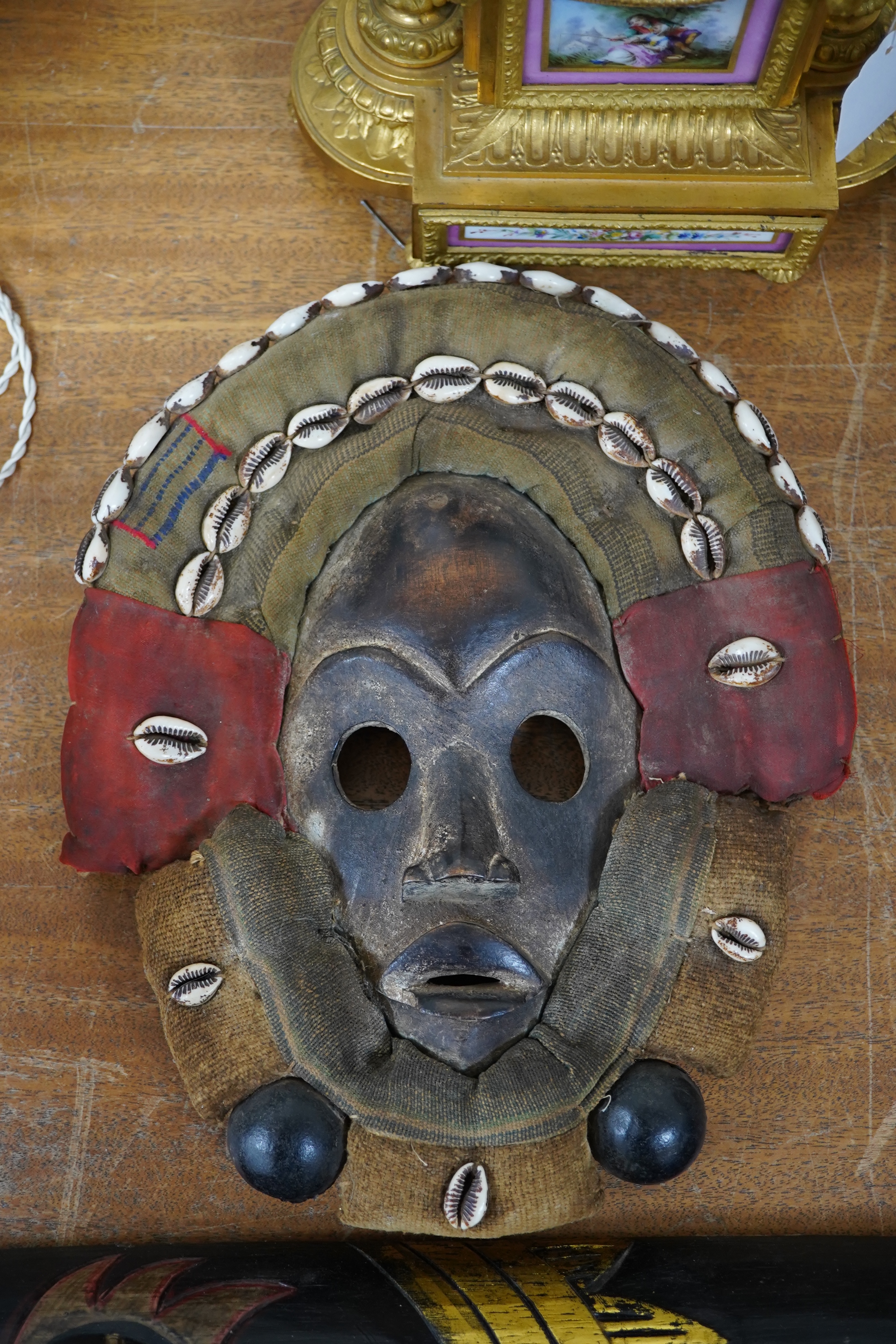 African art - a Liberian/Ivory Coast Dan mask with shell mounts together with another, largest 100cm. Condition - fair to good